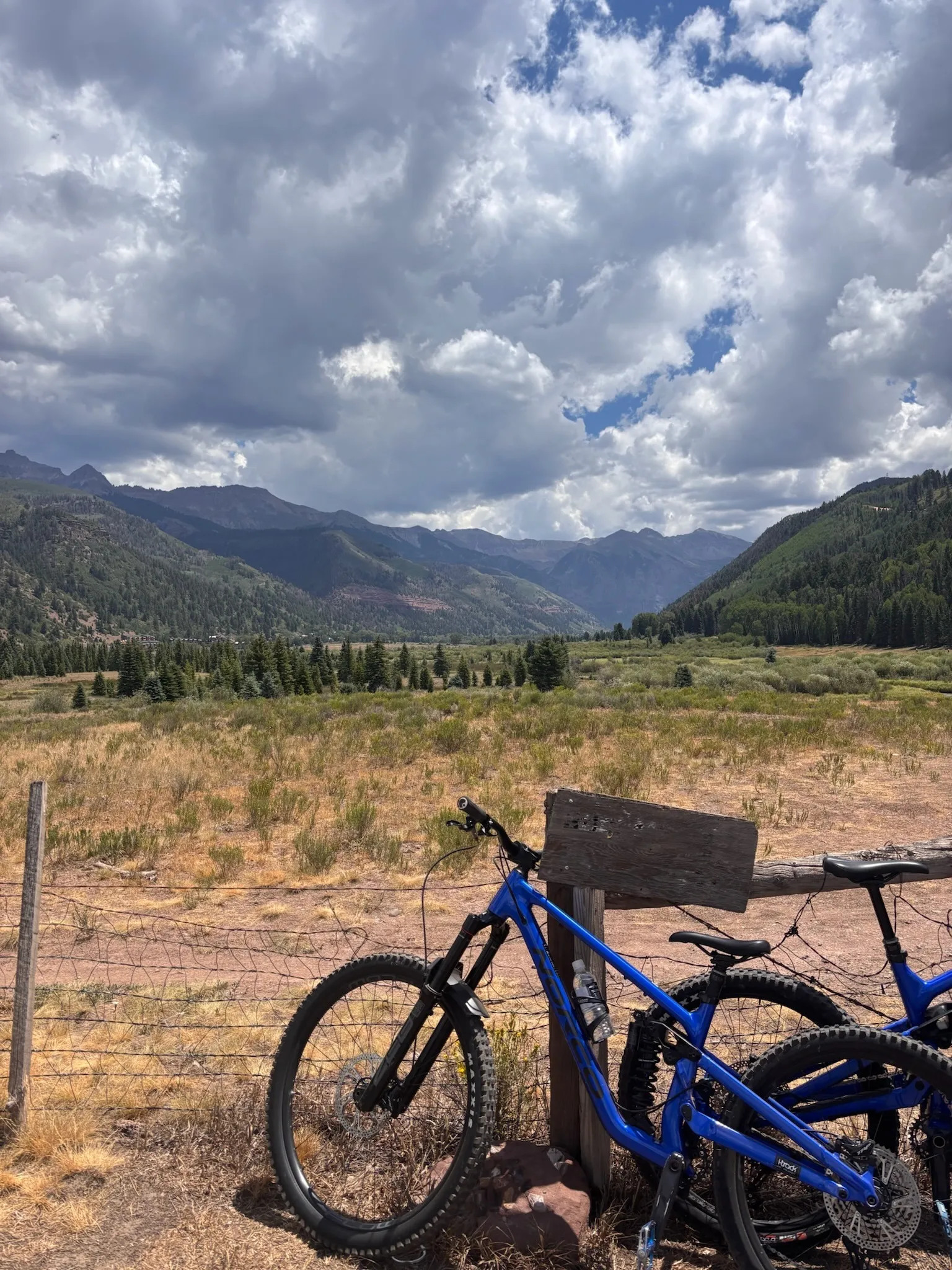 Mountain bikes leaned at the valley floor, storm clouds building over the box canyon
